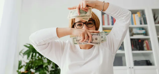 Woman holding dollar bills
